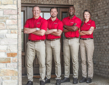 Four courteous HomeTeam inspectors posing for a picture