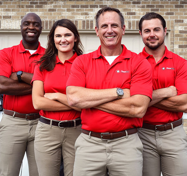 Four HomeTeam employees smiling
