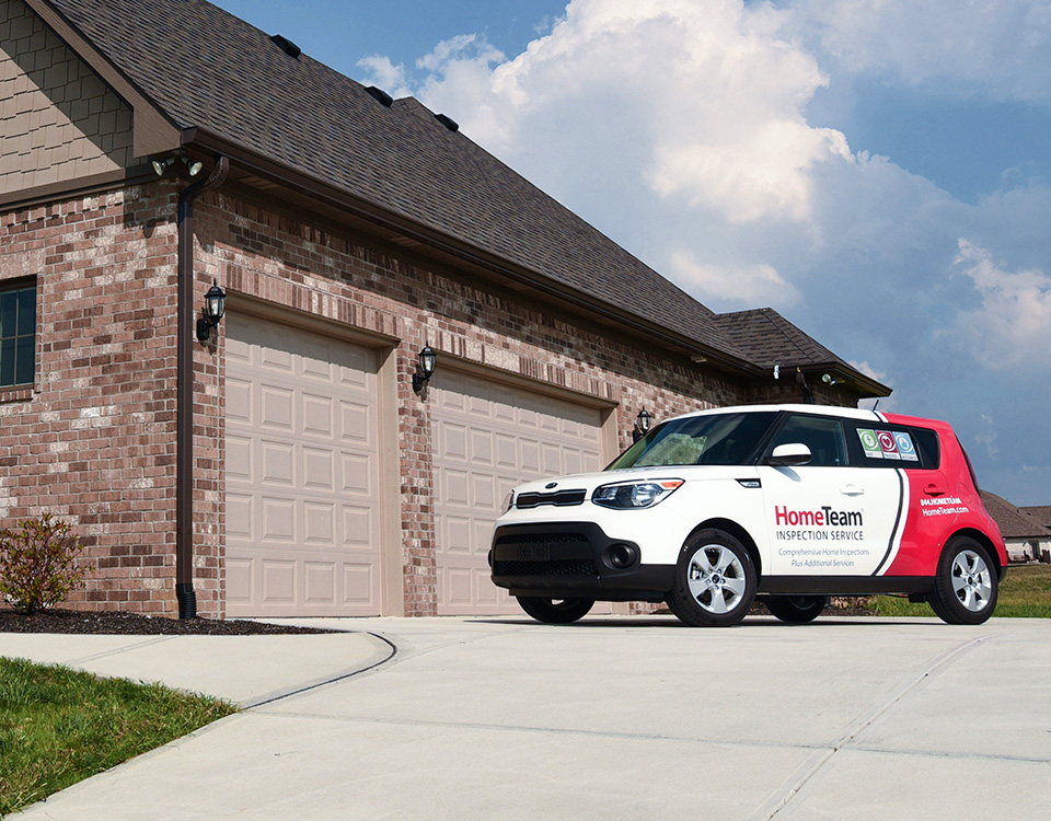 HomeTeam vehicle outside a Spring Hill for radon inspection